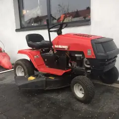 Czerwony traktorek kosiarka Yard Machines. Dowiedz się, jak zdjąć koło w kosiarce traktorku, by ułatwić konserwację.