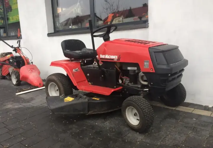 Czerwony traktorek kosiarka Yard Machines. Dowiedz się, jak zdjąć koło w kosiarce traktorku, by ułatwić konserwację.